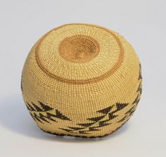 a woven basket with black and white designs on it