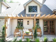 an outdoor patio with wooden furniture and potted plants