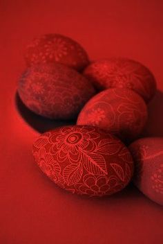 some red and white eggs on a red surface