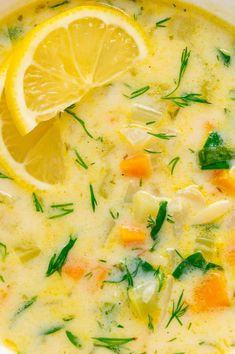 a close up of a bowl of soup with lemon