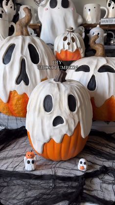 halloween pumpkins decorated with black and white icing, spooky eyes and ghost noses