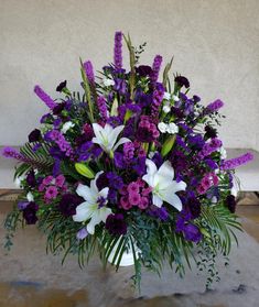 a vase filled with purple and white flowers