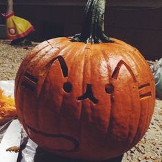 a carved pumpkin with faces drawn on it