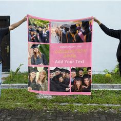 two people holding up a pink banner with photos of graduates and their families on it