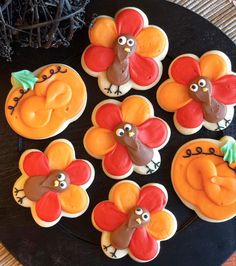 decorated cookies in the shape of turkeys on a plate