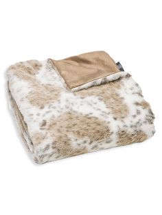 a blanket with white and brown spots on it