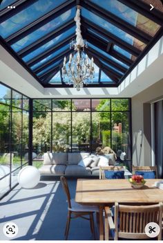 a living room filled with furniture and a glass ceiling