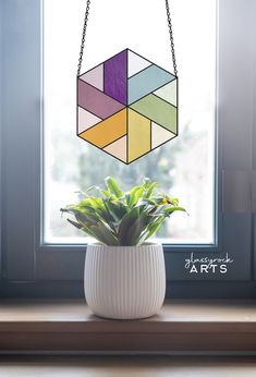 a potted plant sitting on top of a window sill