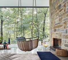 a hanging basket chair in front of a fireplace