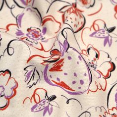 a close up view of a colorful fabric with flowers and cats on it's surface