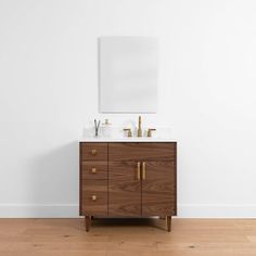 a bathroom vanity with two sinks and a mirror on the wall next to a wooden floor