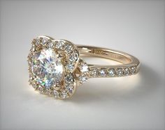 an engagement ring with two round diamonds in the center and side stones on each band