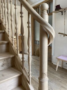 a wooden staircase in a house with white walls