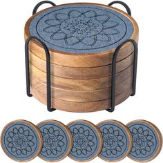 four wooden coasters with metal handles and flower design on the top, sitting next to each other