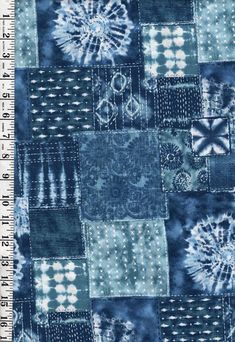 a blue and white patchwork pattern on fabric