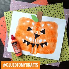 some crafting supplies are laying on top of each other, including an orange pumpkin