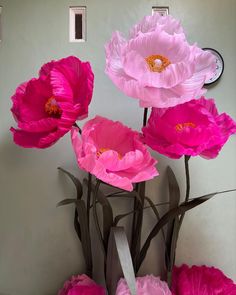 pink paper flowers in front of a white wall