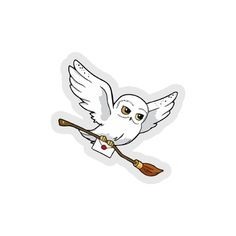 a white bird flying with a broom on it's back and its wings spread out