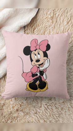 a pink pillow with a cartoon minnie mouse on it