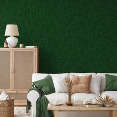 a living room with green wallpaper and white furniture