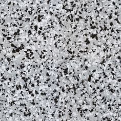 black and white speckles are on the surface of this granite flooring material