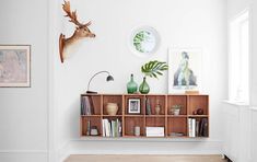 an article in a magazine about decorating with deer heads on the wall and shelves