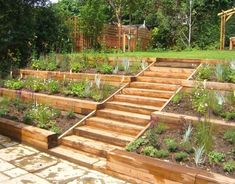 an outdoor garden with wooden steps leading up to it