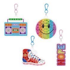 four key chains with different designs and colors on them, one has a smiley face