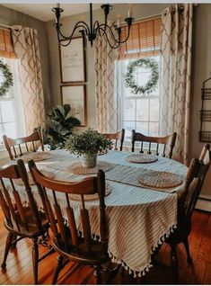 a dining room table with chairs and a potted plant on top of the table