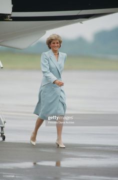 the princess of wales walking towards an airplane