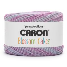 yarn that is purple and white with the words canon written on it in black lettering