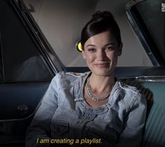 a woman sitting in the back seat of a car