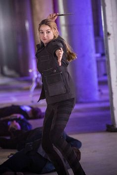 a woman in black jacket and leggings on the street