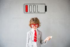 a little boy wearing red glasses and a suit