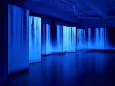 an empty room with blue walls and lights