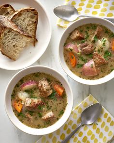 three bowls filled with soup next to slices of bread on top of a yellow and white napkin