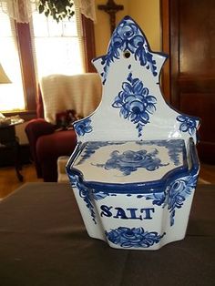 a blue and white vase sitting on top of a table