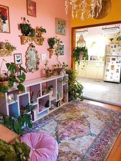 a living room filled with furniture and lots of plants