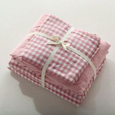 three folded pink and white checkered cloths