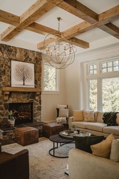 a living room filled with furniture and a fire place in front of a stone fireplace