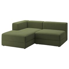 a large green couch sitting on top of a white floor