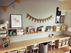 a room with wooden shelves filled with books and toys