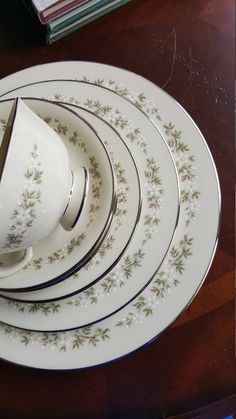 a stack of white plates with flowers on them