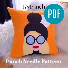 an orange pillow with a woman's face on it and the text punch needle pattern