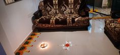 a living room filled with furniture and flowers on the floor