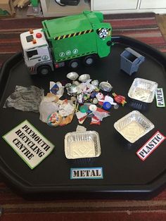 a tray with various items on it and a toy truck in the middle one is green