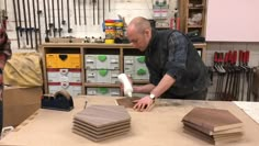 two men are working on some wood in a shop, one is cutting and the other is making something out of plywood