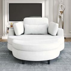 a living room with a large white round couch