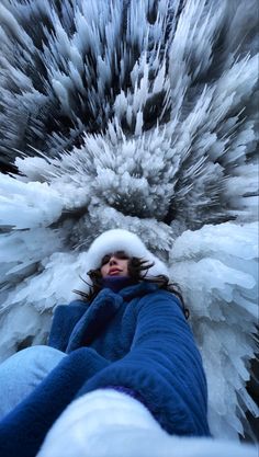 a woman is laying down in the snow