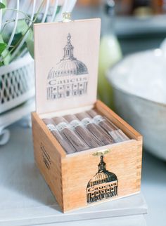 a wooden box filled with matches on top of a table